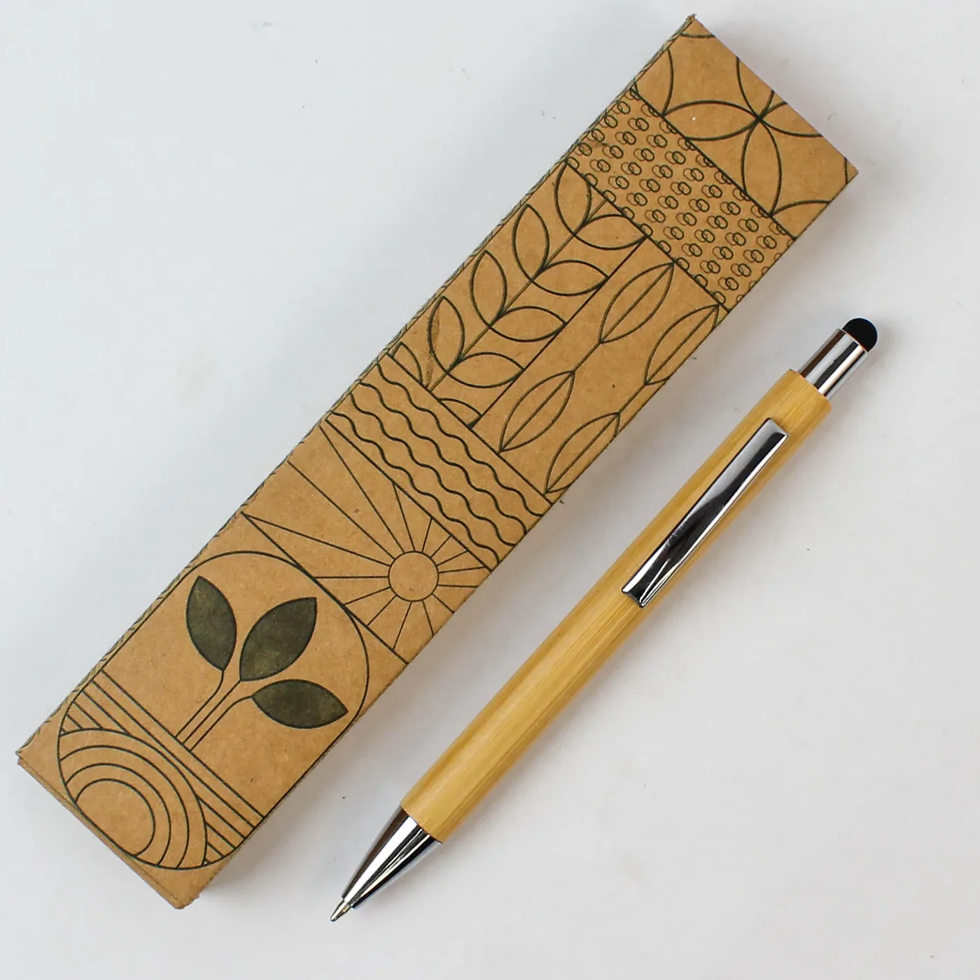 The bamboo stylus pen lying beside its closed printed kraft box