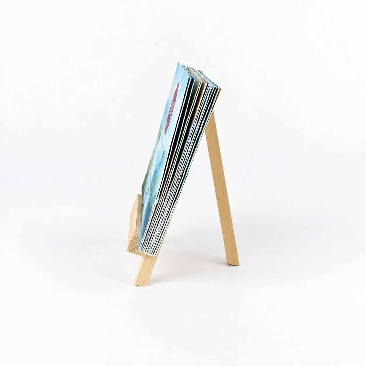 BG61-pro stack of landscape seed-paper cards on the wooden easel, seen from the side