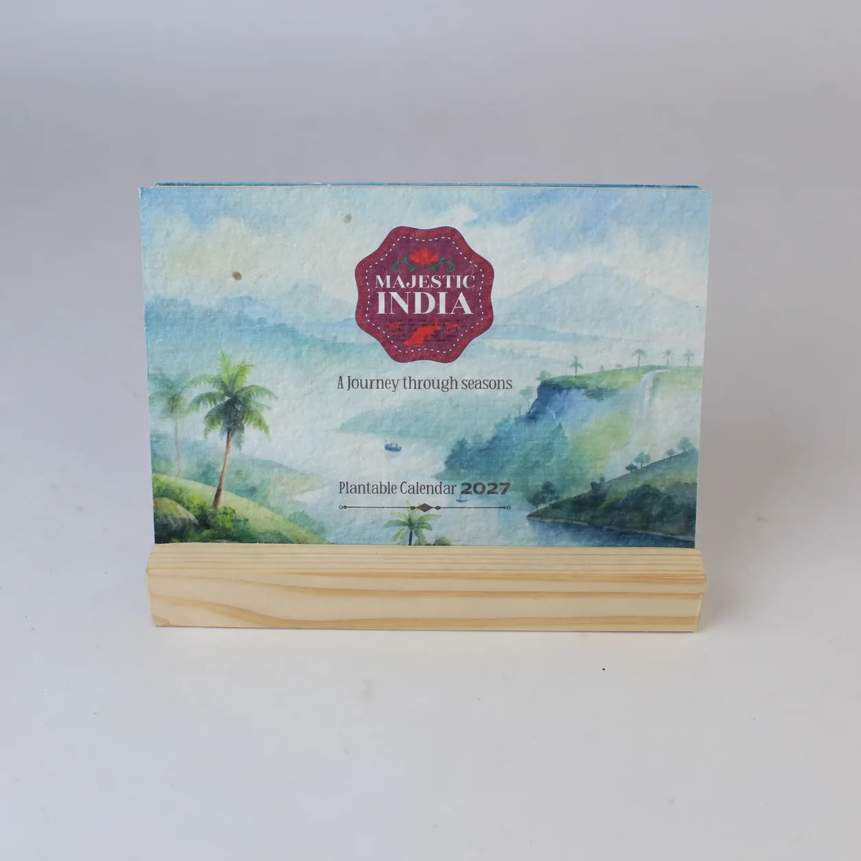 BG65 Majestic India 2027 calendar cover standing in a wooden base with a slot (year digitally updated from the 2026 photograph)
