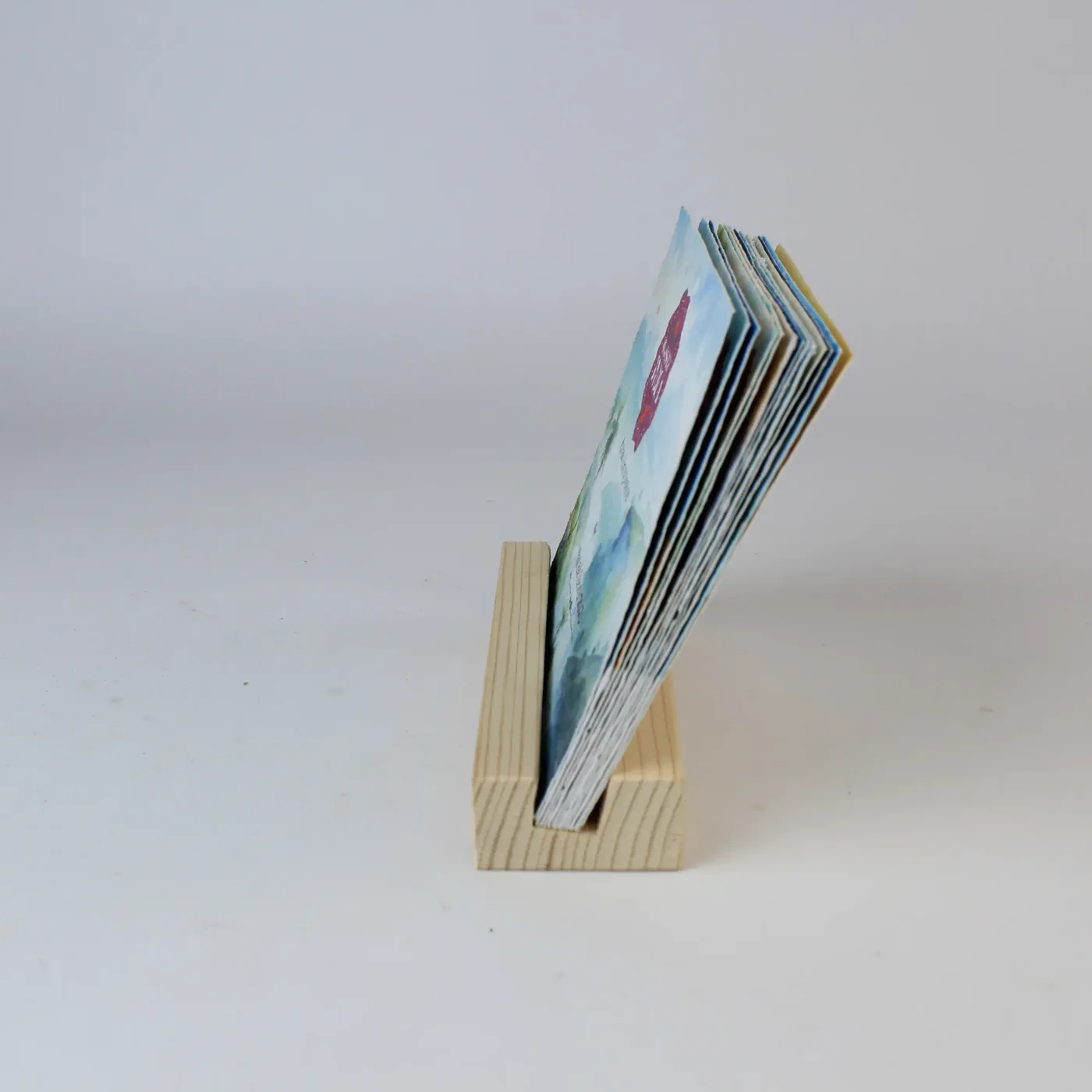 BG65 stack of seed-paper calendar cards seated in the slot of the wooden base, seen from the side
