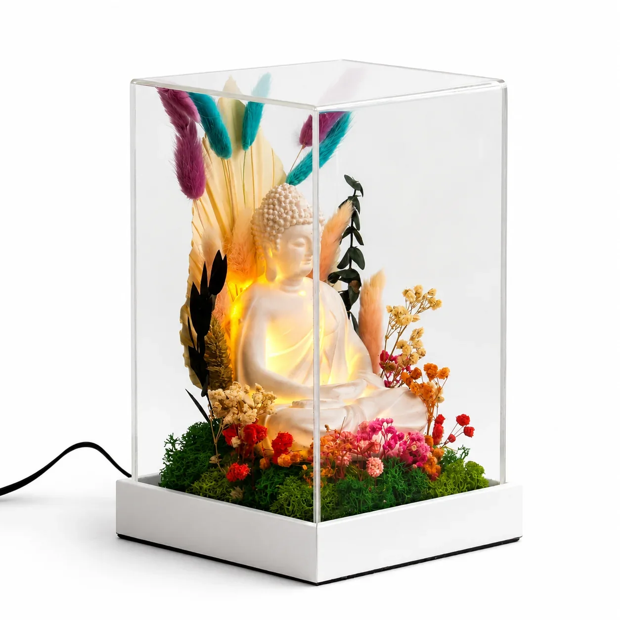Lit Buddha Terrarium 9 inch on a white background: a glowing white Buddha among preserved flowers and moss in a tall clear acrylic cover on a white base