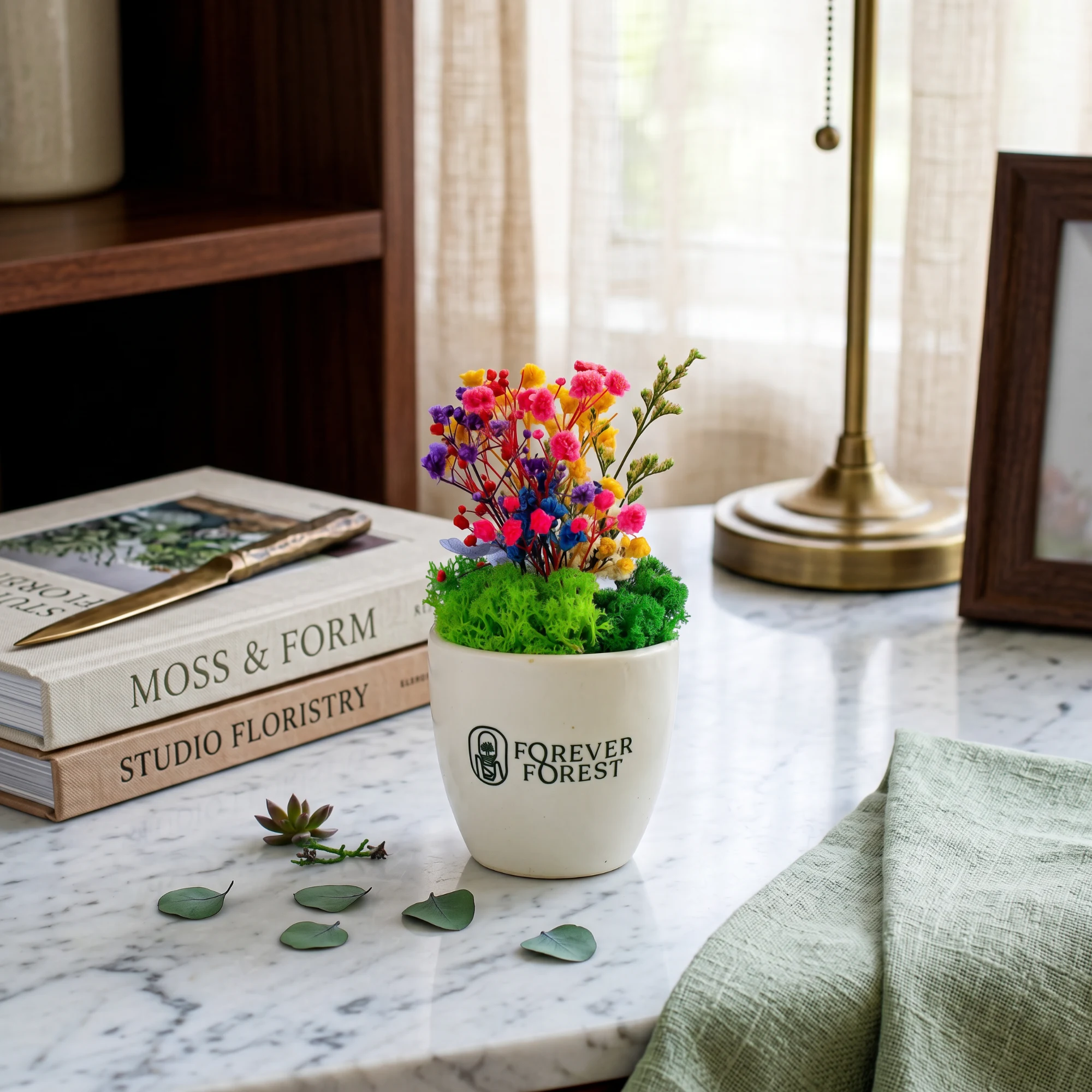 Ceramic Flower Pot with preserved flowers and Forever Forest print on a desk