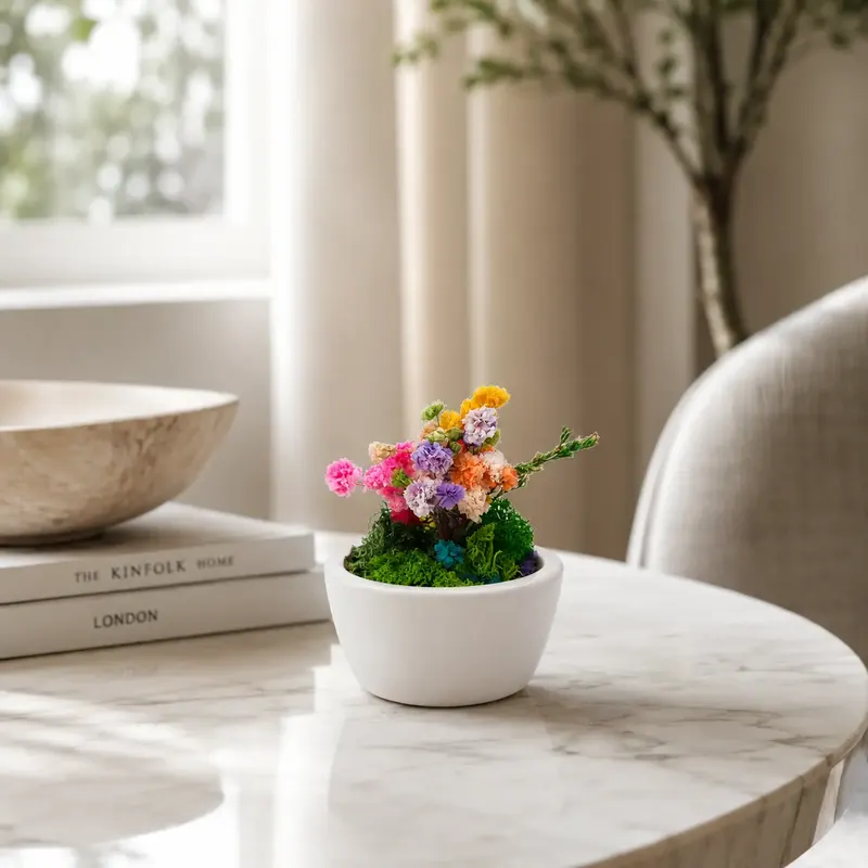 Ceramic Forest Mini bowl of preserved moss and dried flowers on a side table