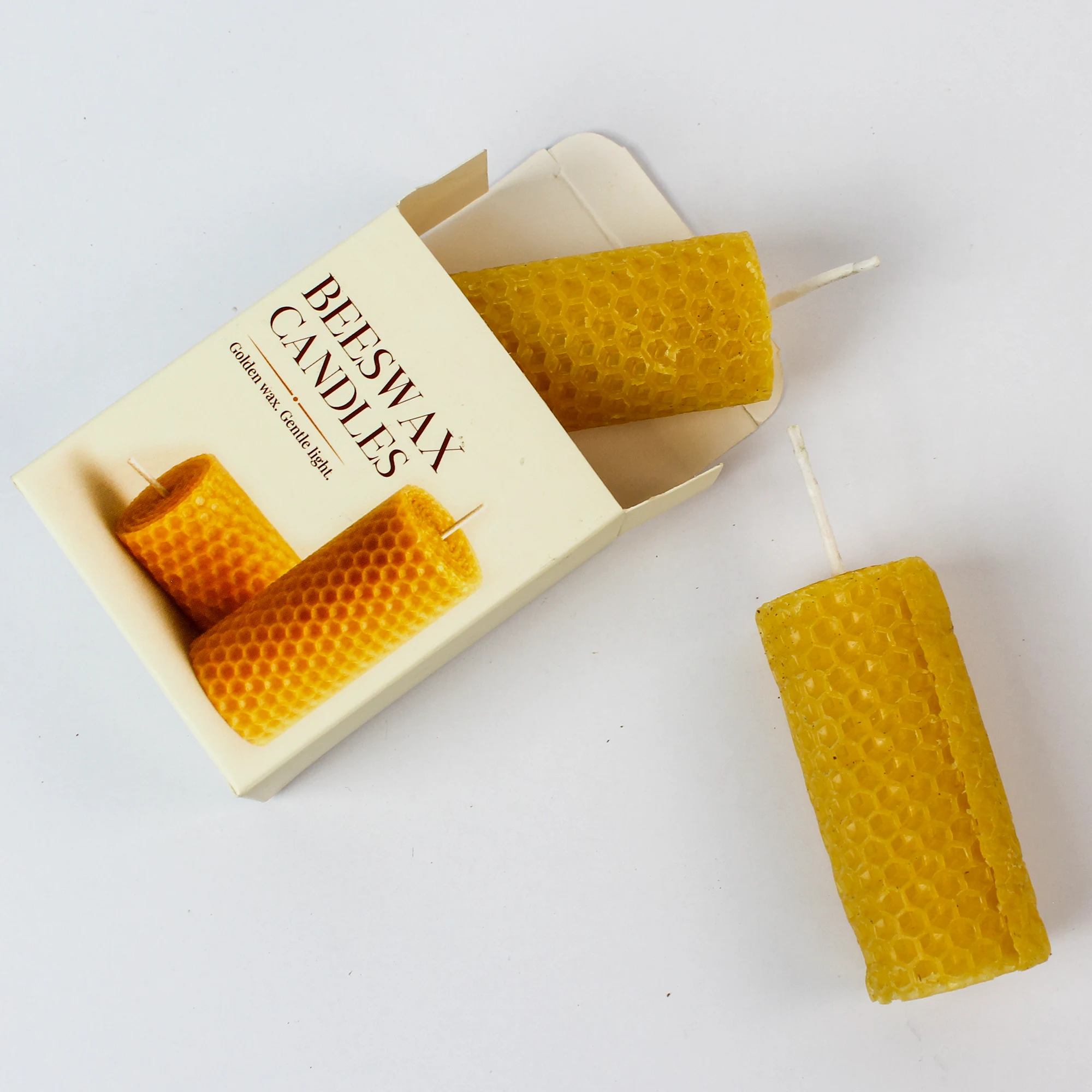 DK11 printed beeswax candle box open beside the two yellow candles