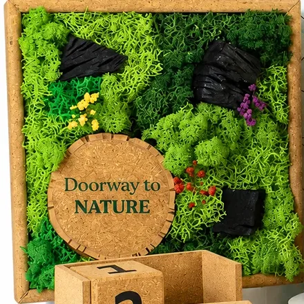 The 9-inch cork-framed moss artwork with bark accents, small flowers and a cork circle printed with a sample message