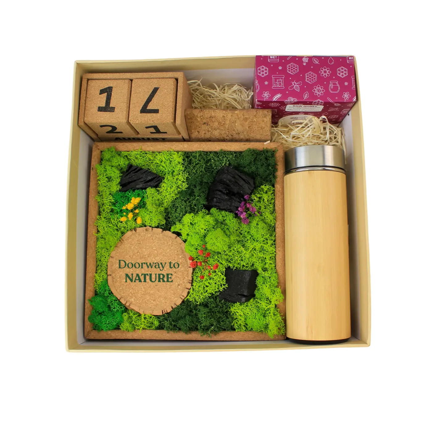 The Forest Chronicles Box open from above: the moss frame, the cork calendar, the honey box and the bamboo flask inside a cream box