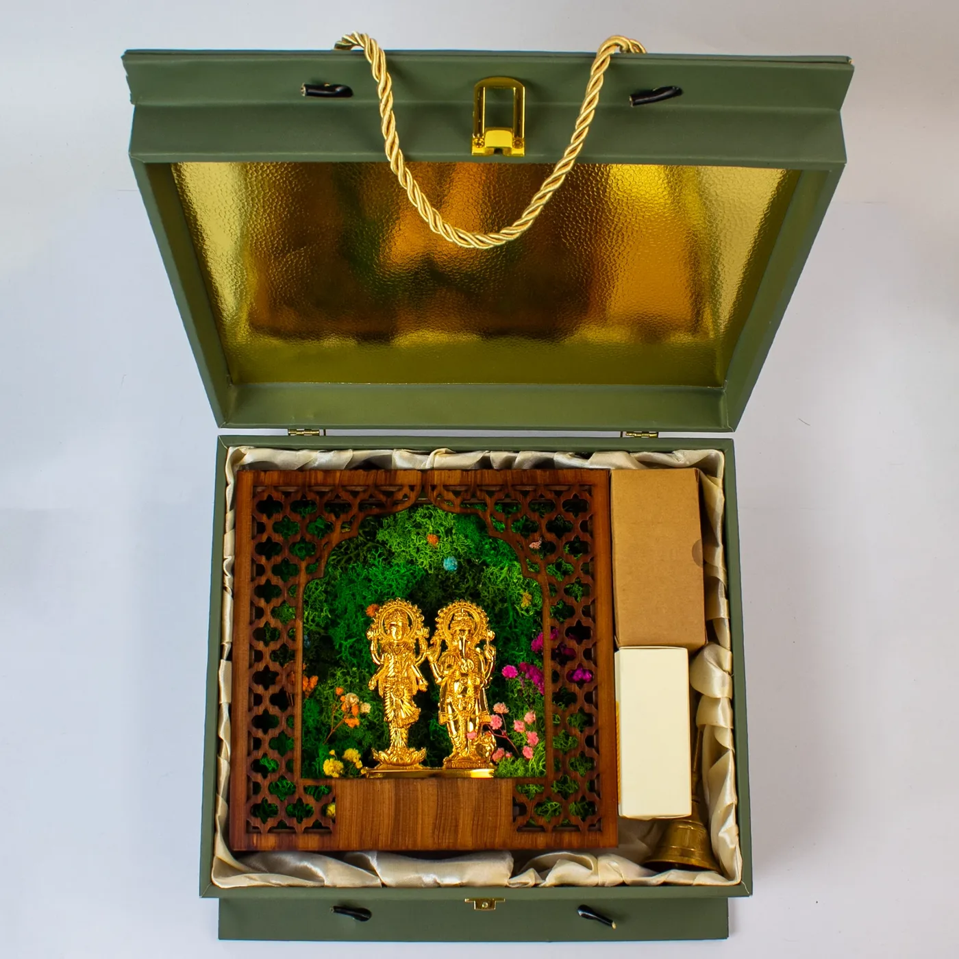 The Emerald Forest Chest open from above: gold foil inside the lid, an ivory satin bed holding the mandir, the adapter box, the candle box and the ghanti