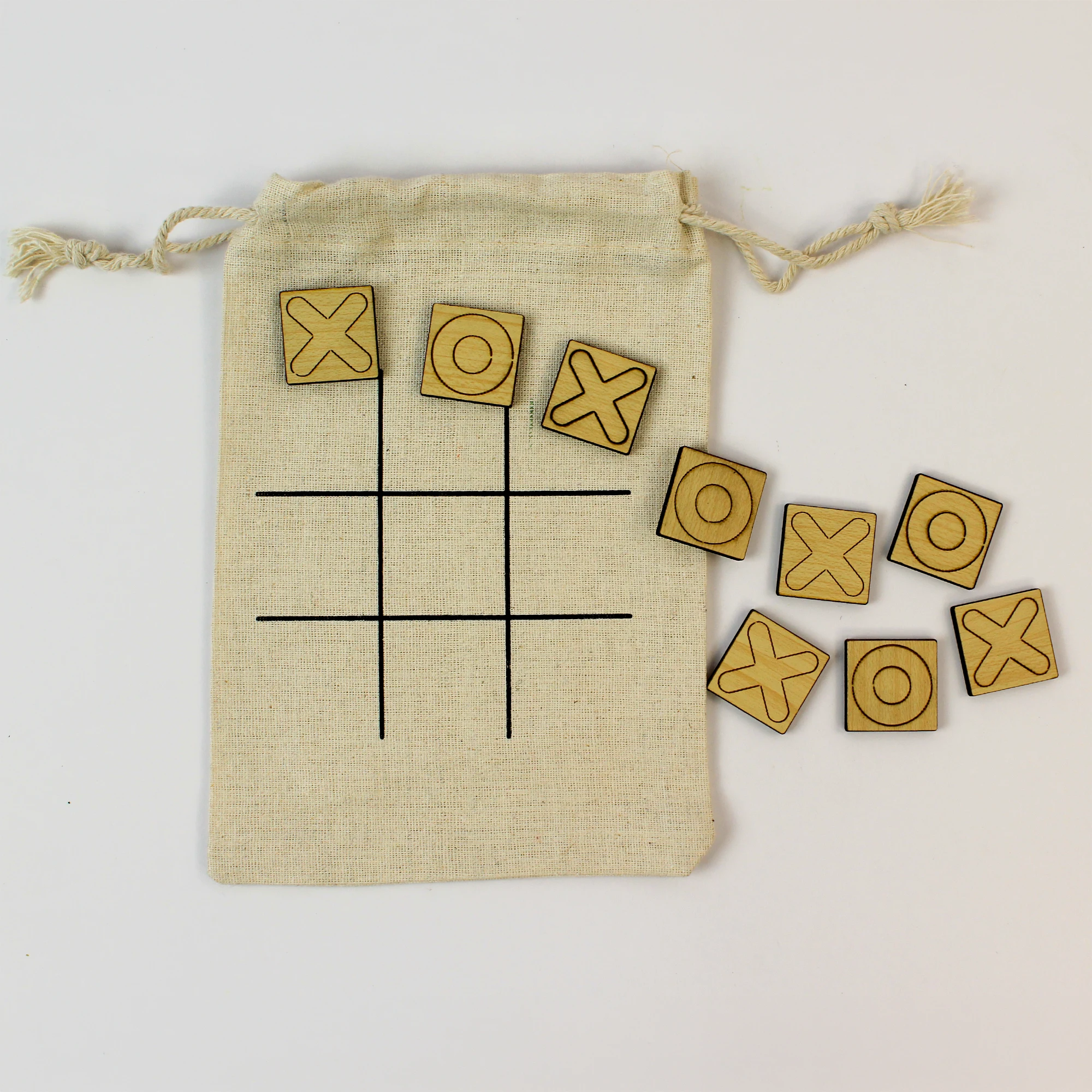 T3-B square MDF X-and-O pieces beside a cotton pouch game board