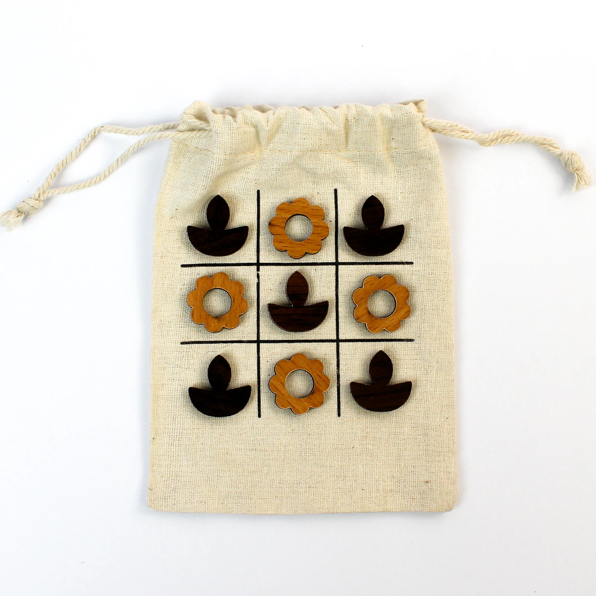 T3-D diya-and-bloom MDF game pieces arranged on the cotton pouch board
