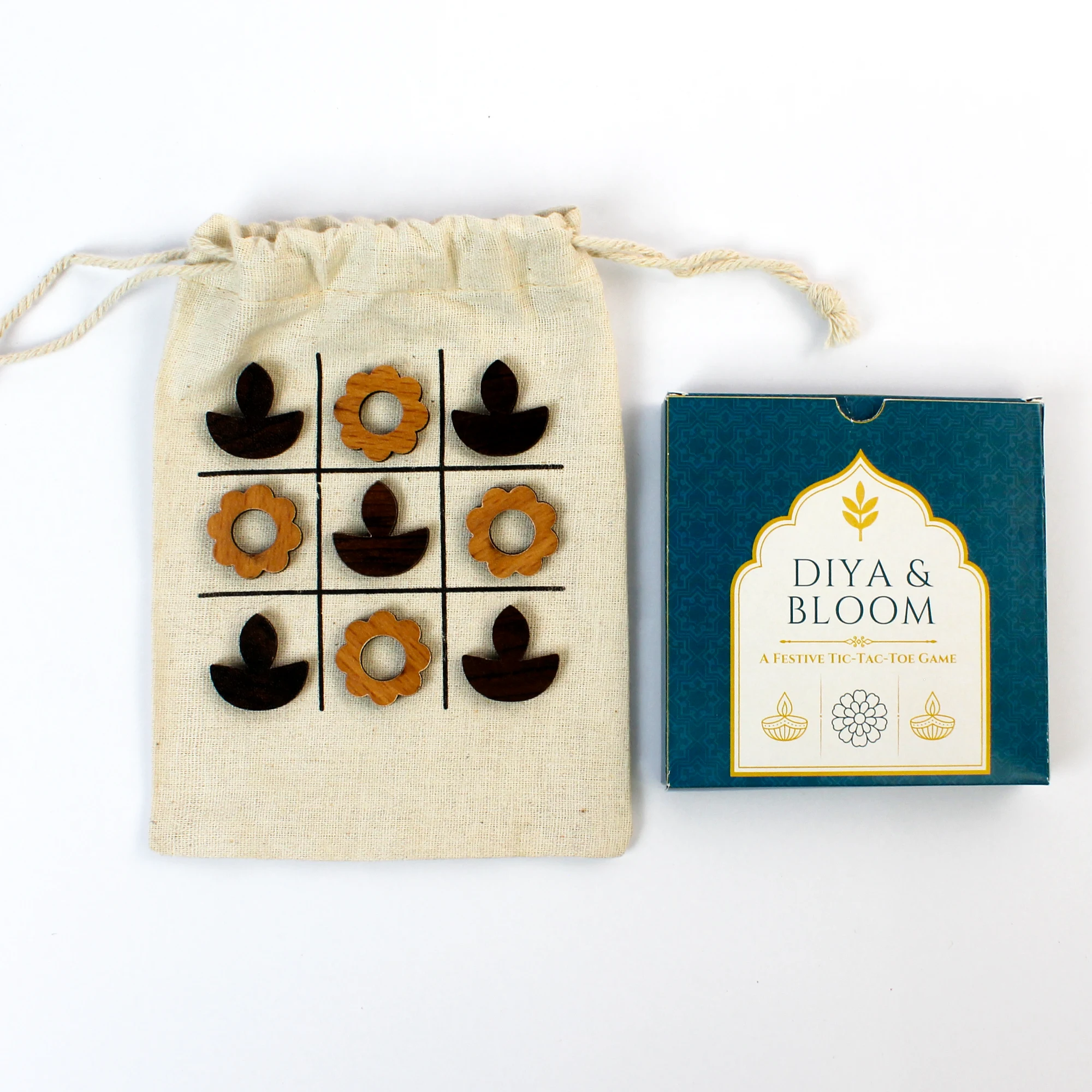 T3-D diya-and-bloom pieces and example presentation beside the cotton pouch board