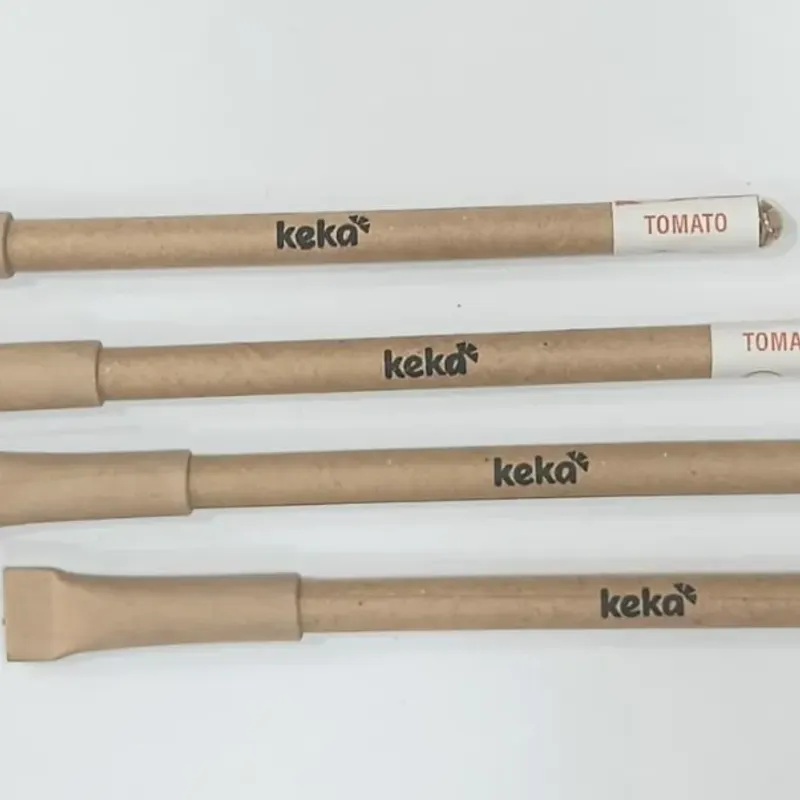 Branded plantable paper pens laid out in a row