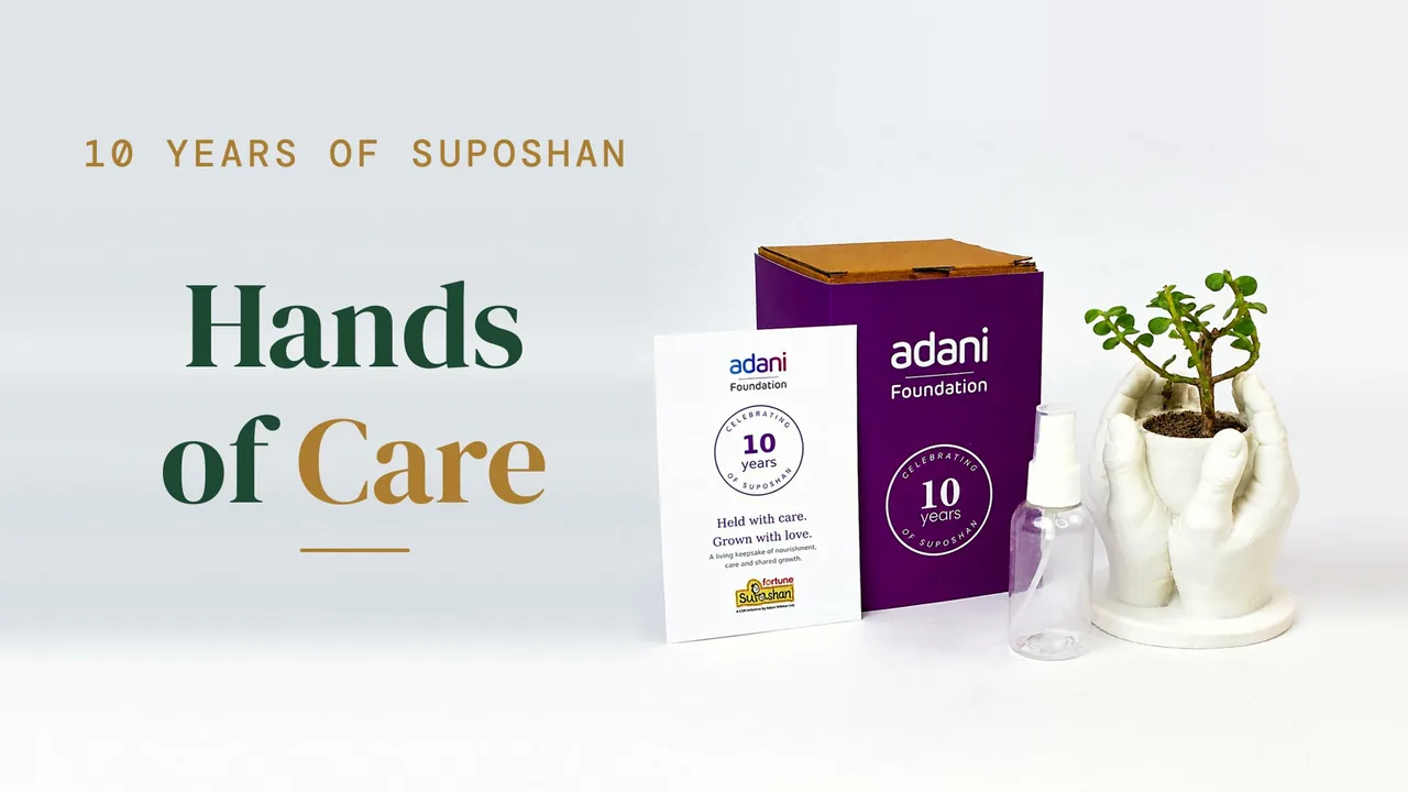 The Hands of Care keepsake: an Adani Foundation box, a keepsake card, a spray bottle and a jade plant in a cupped-hands planter, beside the film's title