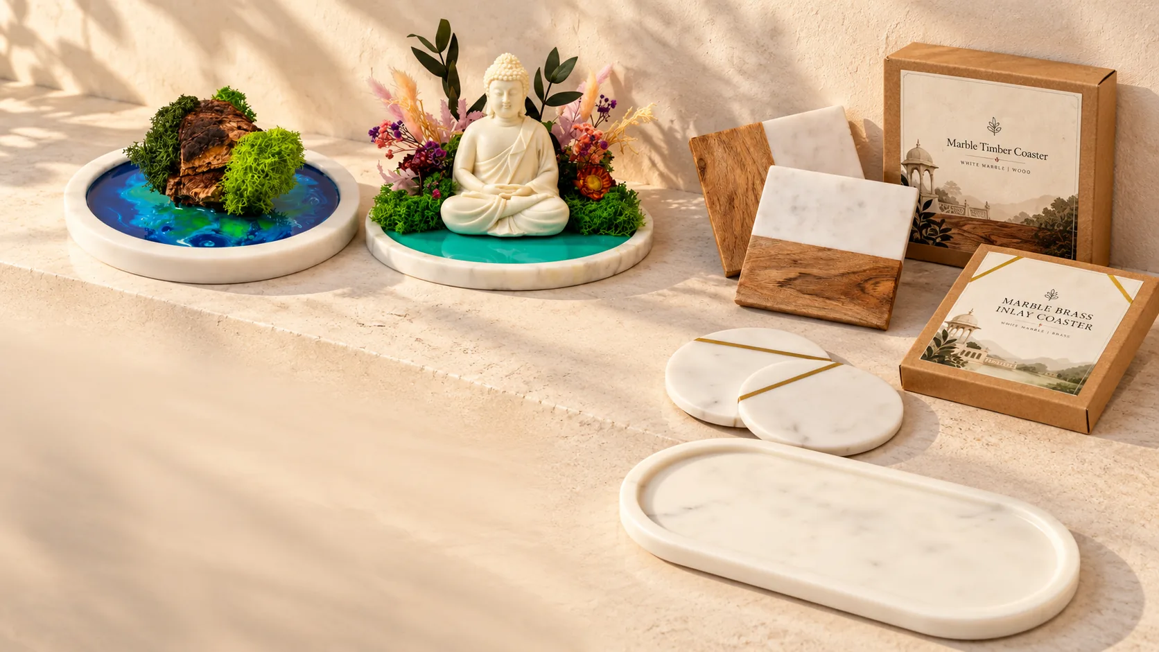 Five marble pieces on a stone ledge: a round tray with a resin pond and moss, a round tray with a Buddha and preserved flowers, marble and wood coasters, round marble coasters with a brass inlay and an oval marble tray