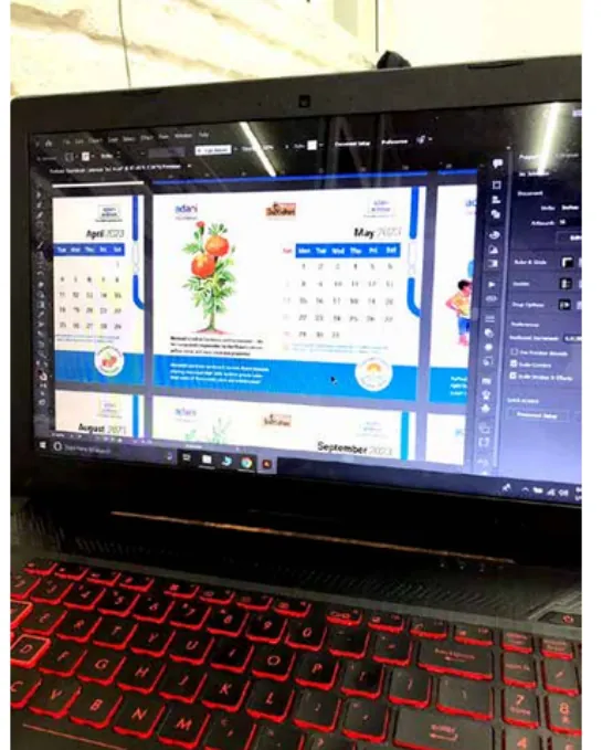 The calendar pages being laid out on a laptop