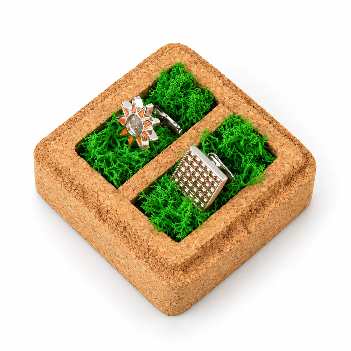 Overhead view of two cufflinks in separate botanical-lined wells