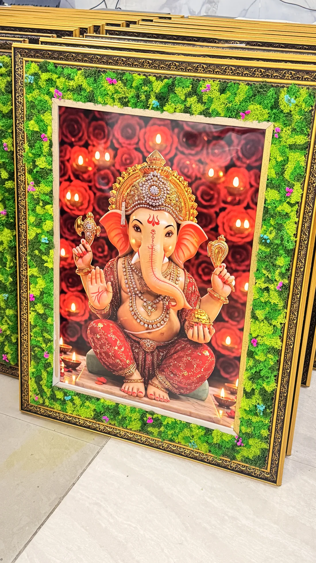 Finished Ganesh frames standing in a row in the workshop