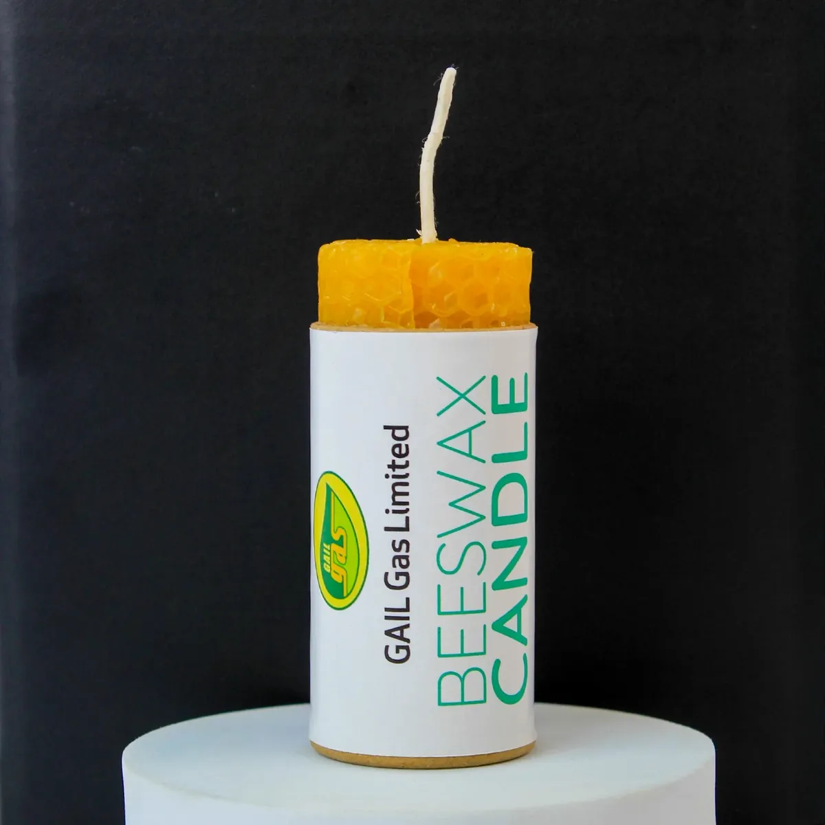 A beeswax candle in a cork box with the client’s mark