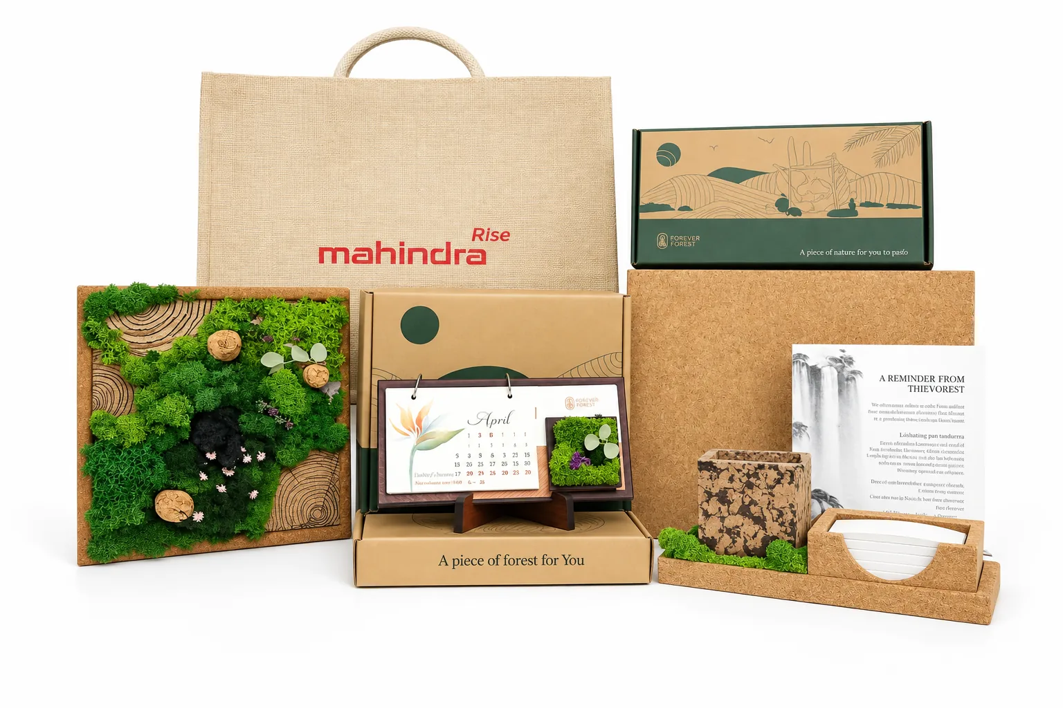 A jute bag printed with the client’s name, a preserved-moss frame, a plantable calendar on an easel, a kraft box reading A piece of forest for you, a cork notebook, coasters and cards