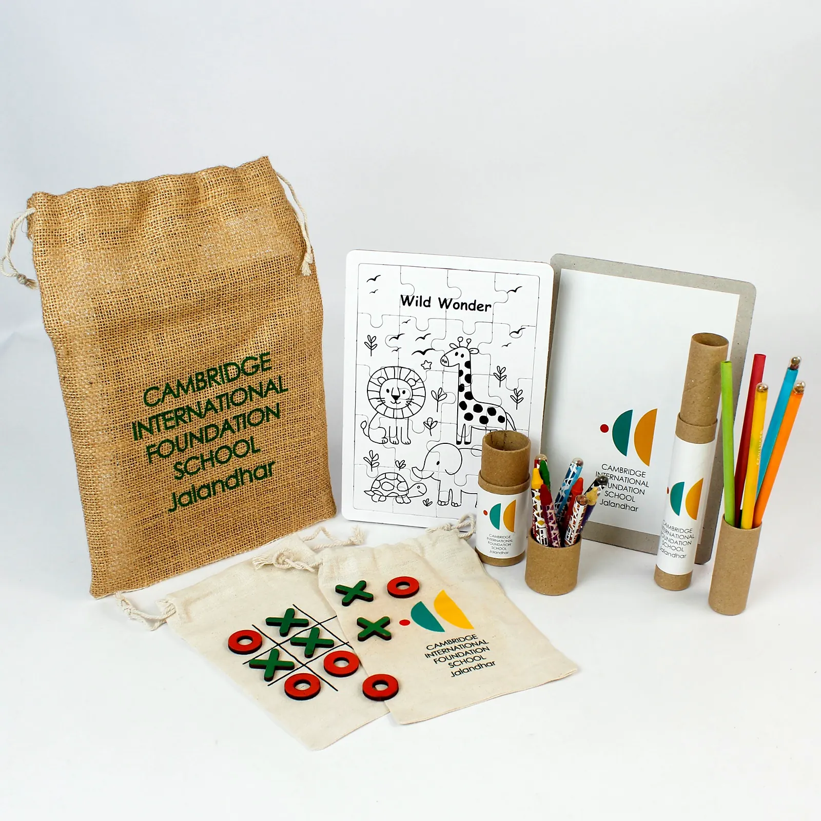 A jute bag, a colouring puzzle, crayons and seed pencils in tubes, and a tic-tac-toe cotton bag