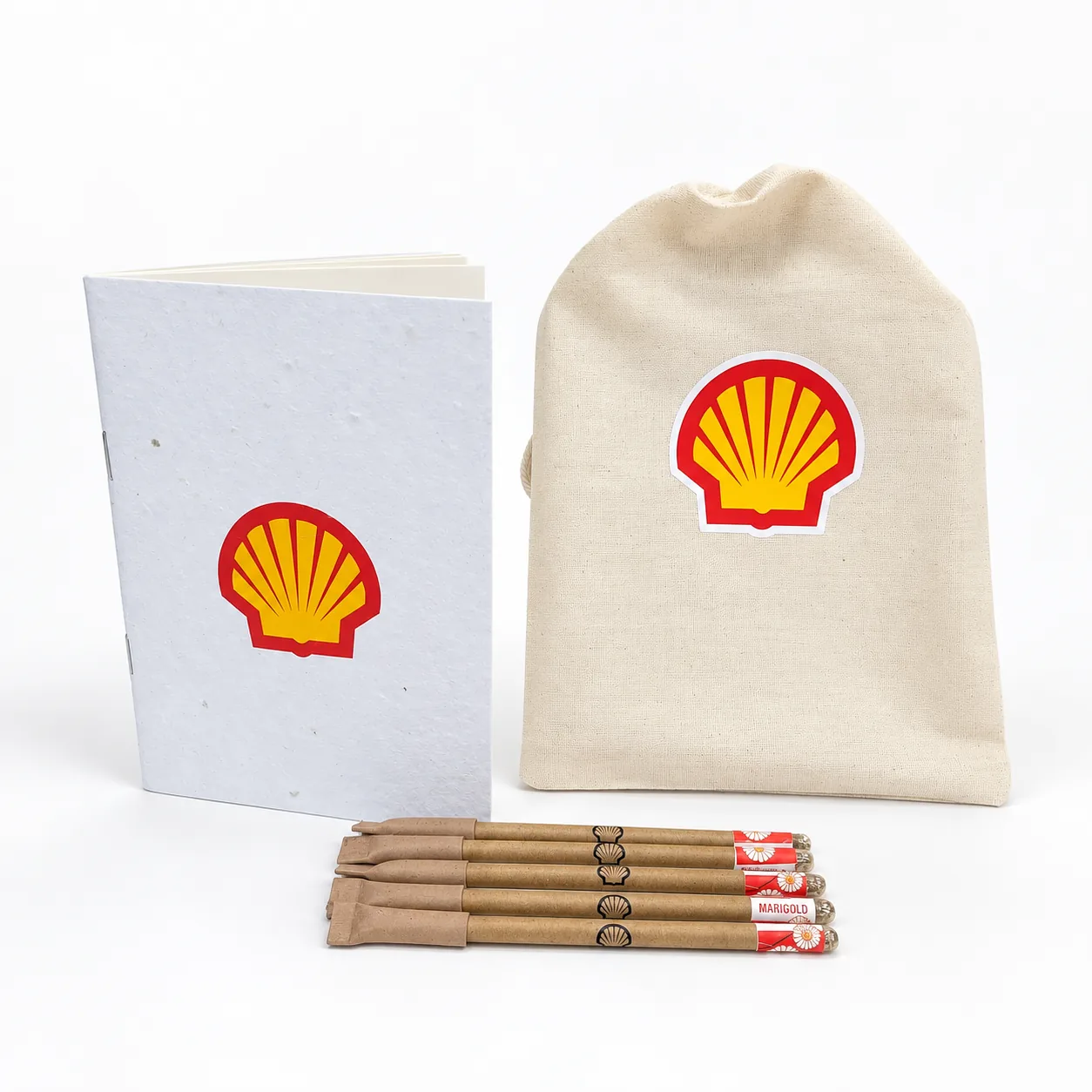 A seed-paper notepad and a cotton drawstring bag, each with the client’s pecten in red and yellow, and four seed pencils in kraft sleeves