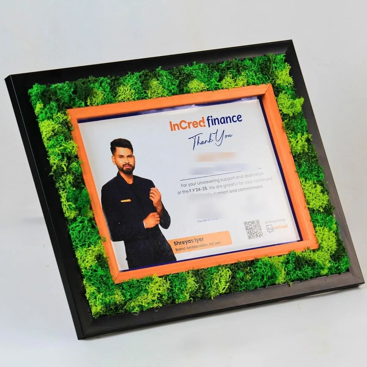 A moss frame around a personalised certificate