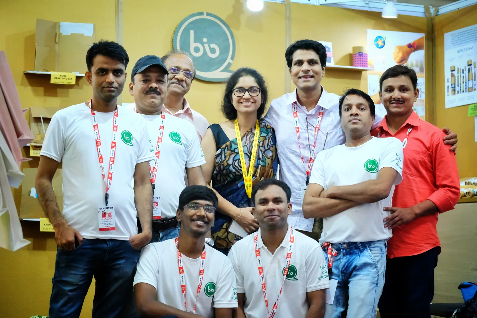 The team in white T-shirts posing together at the bioQ stall