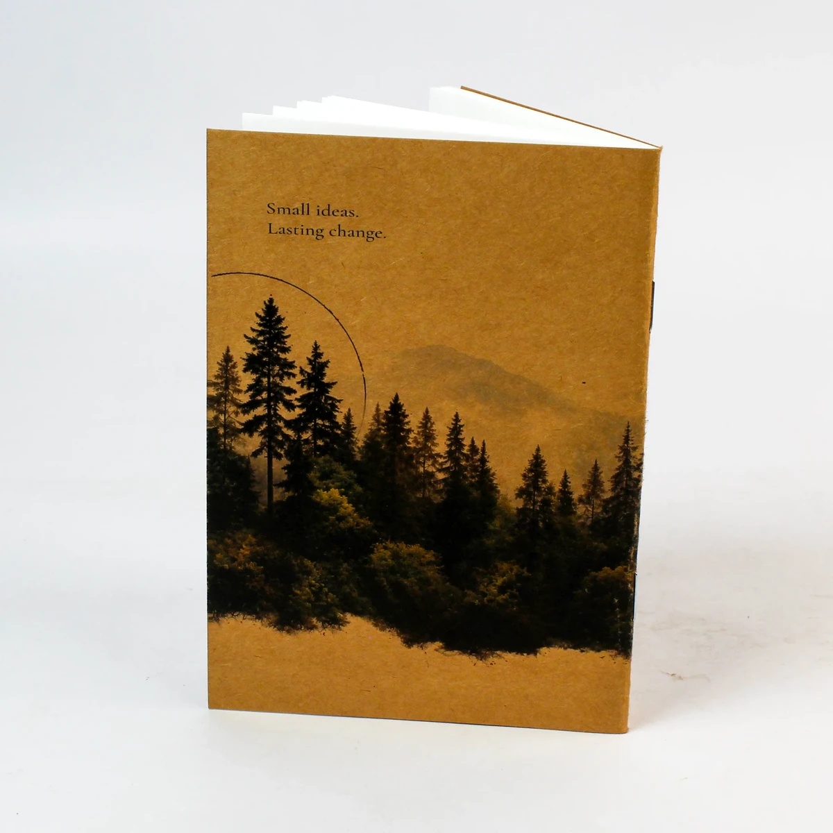 Kraft notebook back with trees and the message Small ideas, Lasting change