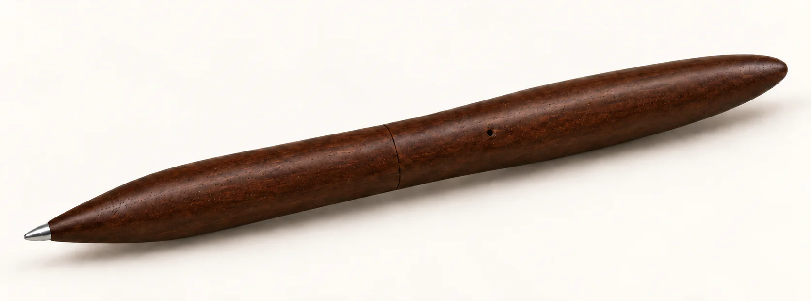 Design render of NOTE’s dark wood, capless two-piece pen: an exposed metal writing tip, flush middle joint, side vent and rounded tail.